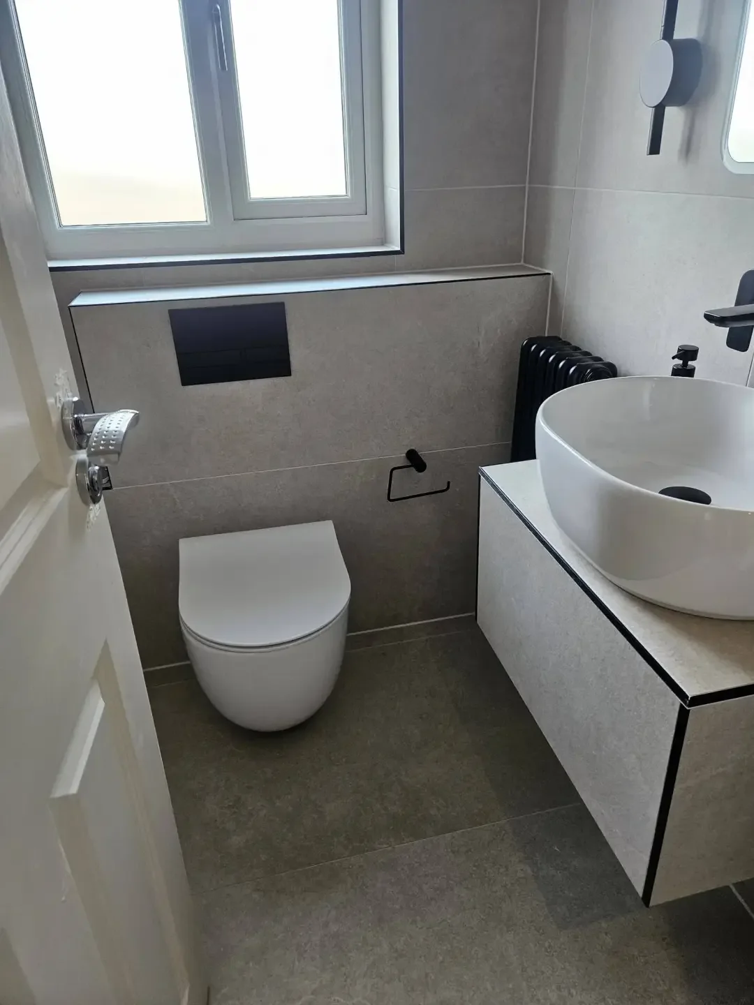 Wall hung toilet and floating vanity unit in a completed Preston bathroom