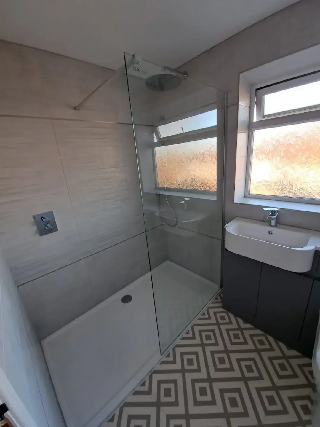 Walk in shower with patterned floor tiling fitted in Preston