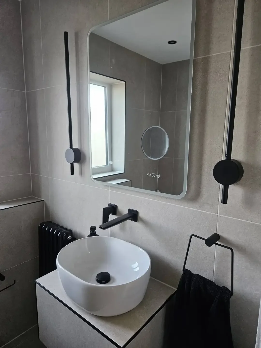 Counter top basin and black towel radiator in a Preston bathroom